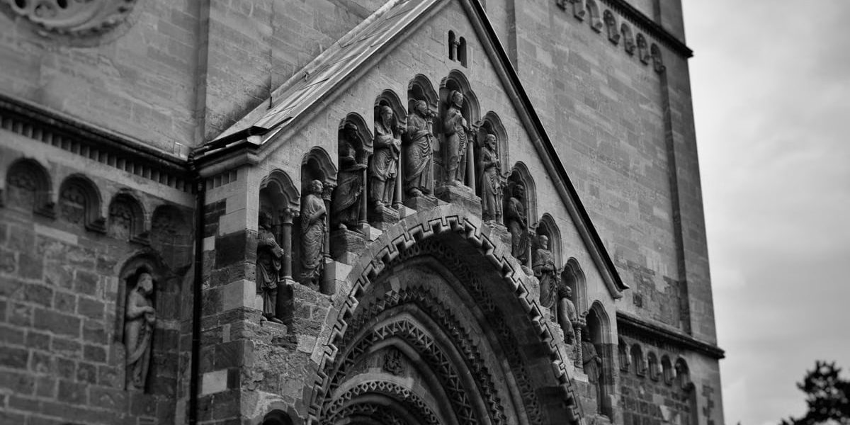 Vintage-style photograph capturing the intricate details of Ják Church's façade in Hungary.