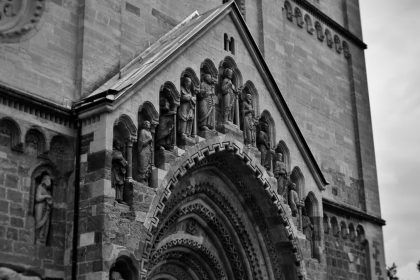 Vintage-style photograph capturing the intricate details of Ják Church's façade in Hungary.